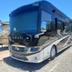20220701_124924 Luxury Newmar RV parked under blue sky