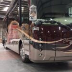 20230419_124343 Luxurious RV parked indoors, showcasing modern design.