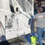 VideoCapture_20230126-091249 Person washing a recreational vehicle with soap.